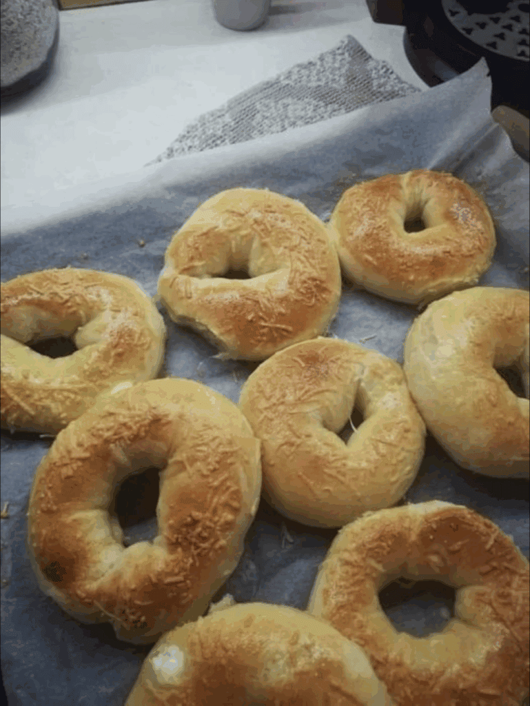 Fresh homemade bagels on parchment paper, perfect for breakfast or brunch.